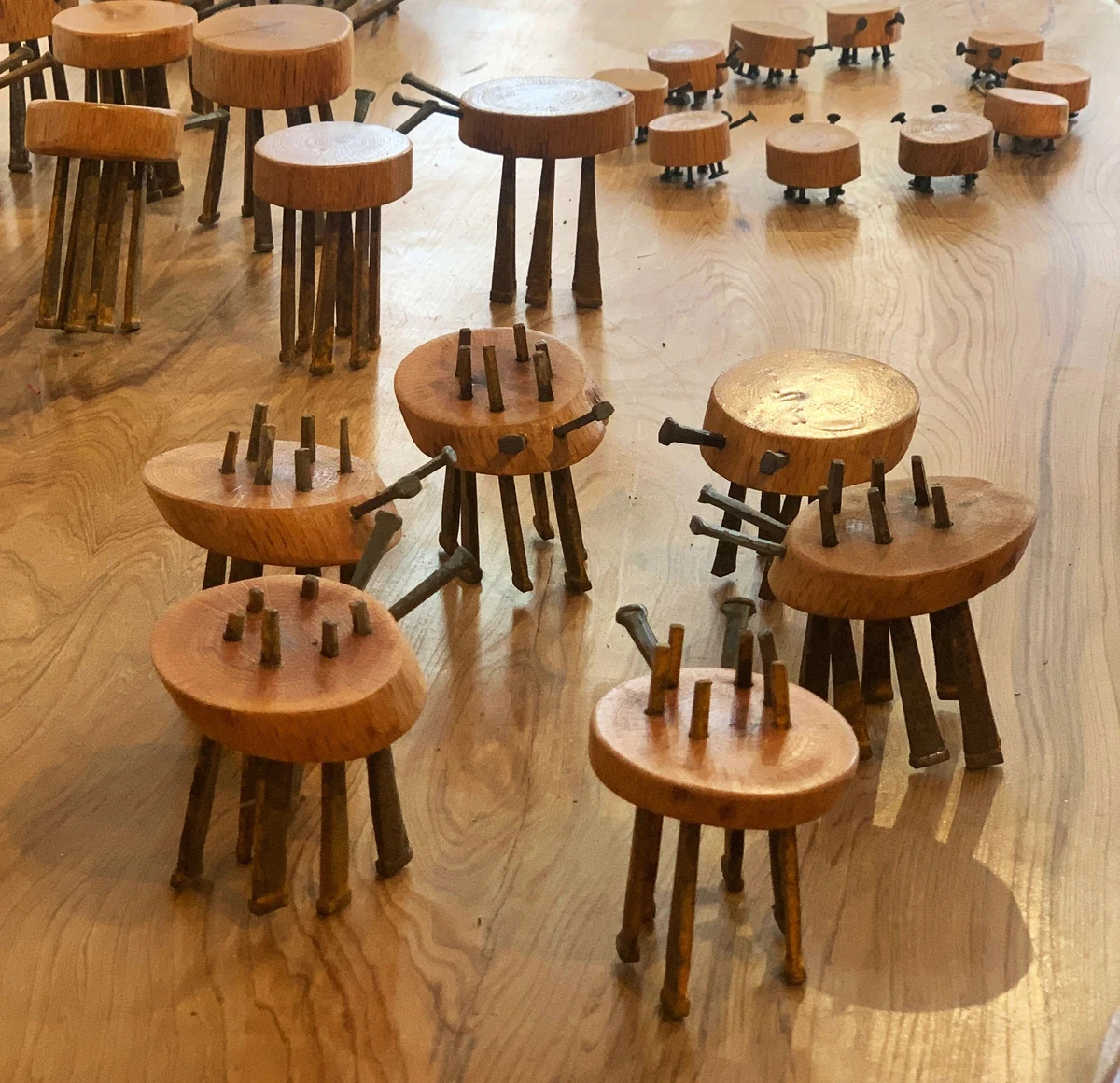 Ferrous Insecta, a group of insect-like sculptures made from wood rounds and nails