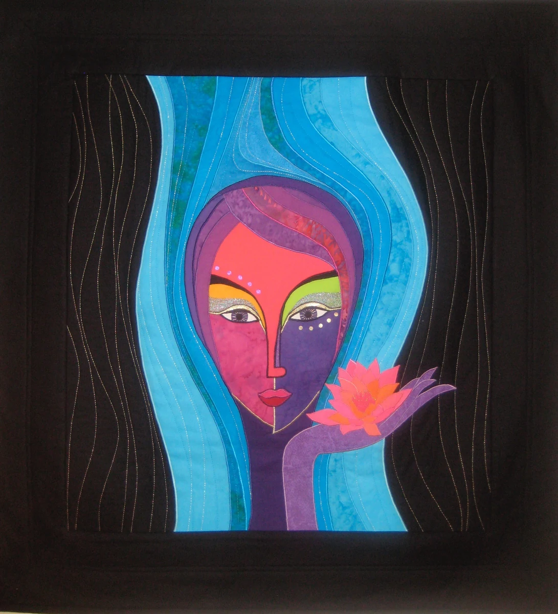 "Water Lily," 40.5 x 42.5 inch art quilt of a stylized woman's face in pink and purple against blue water, holding a pink lotus, on a black border
