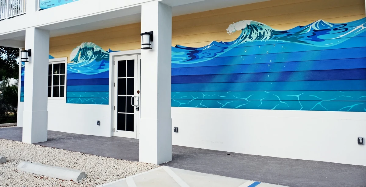 The Ocean Mural, a breaking-wave and underwater scene painted across the exterior wall of REEF's Ocean Exploration Center in Key Largo, by muralist Sydney Prusso