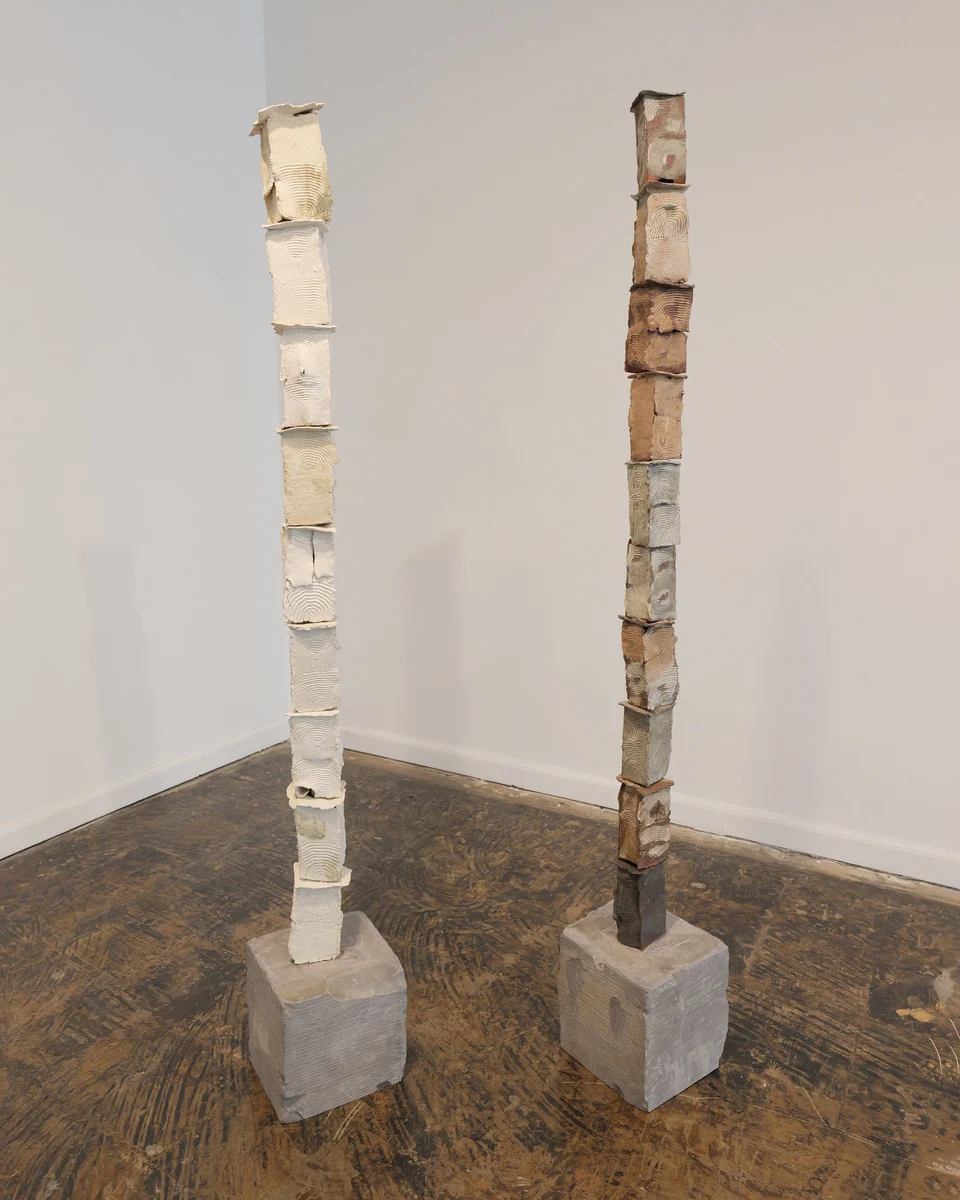 Portal Towers, Chalk and Element: two slender columns of stacked ceramic blocks on concrete bases in a gallery corner